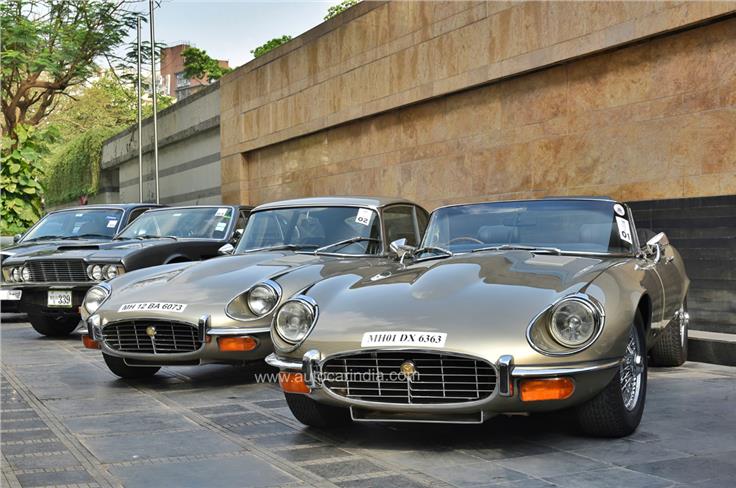 Two pristine examples of Jaguar E-Types &#8211; a coupe and a convertible. Both powered by V12s. An Aston Martin DBS lurking in the background. 
